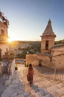Images Dated 17th September 2020: Ragusa Ibla, Sicily. A woman walking on the stairs with Ragusa old town in the background