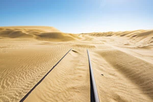 Railway tracks leading into a sand dune, Luderitz, Namibia, Africa