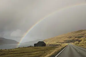 Eysturoy Prints: A rainbow over a sheep house on the Sundini strait between the islands of Eysturoy and Streymoy