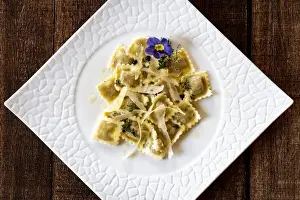 Plate Prints: Ravioli traditional pasta stuffed with game meat in white dish from above