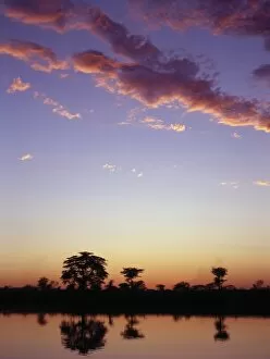 Okavango Collection: The last rays of the setting sun over the Okavango River at Rundu