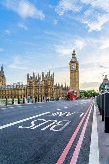 Images Dated 16th August 2022: A red London bus on Westminster Bridge, by Big Ben and the Houses of Parliament