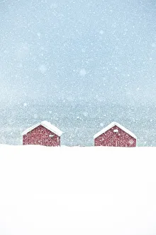 Loneliness Prints: Red rorbu cabins hit by a heavy snowfall in winter, Troms county, Norway