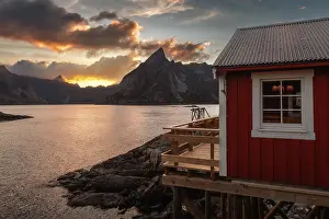 Reine Prints: A red rorbu in Hamnoy catching the last light of the day on a colorful summer sunset
