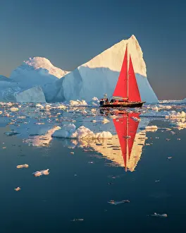 Danish Territory Prints: Red sailboat near icebergs in Disko Bay, Greenland