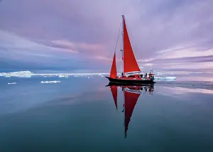 Danish Territory Prints: Red sailboat reflection near sunset on Disko Bay, Greenland