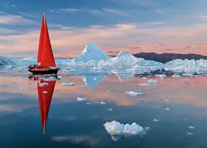 Polar Region Prints: Red sailboat at sunset near icebergs in Disko Bay, Greenland