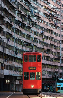Public Transport Prints: Red Tram in front of Monster Buildings, Quarry Bay. Hong Kong, China, Asia
