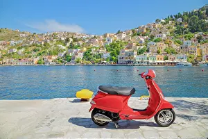Motorcycle Prints: Red vespa scooter parked at Gialos harbour