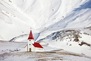 Vik Y Myrdal Prints: Red and white church with snow-covered mountains in the background