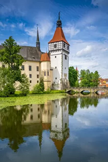 Reflection of Blatna Castle in pond on sunny day, Blatna, Strakonice District, South Bohemian Region, Czech Republic
