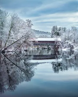 Timber Prints: Reflection of Henniker Covered Bridge in snow, Henniker, New Hampshire, USA