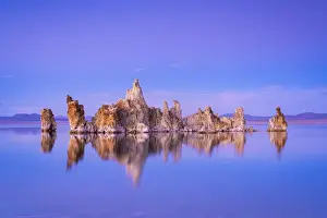 Non Urban Scene Prints: Reflection of rock formation in South Tufa on Mono Lake against blue sky at dusk