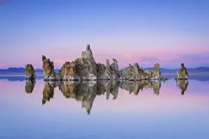 Reflection of rock formation in South Tufa on Mono Lake against blue sky at sunset