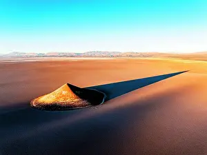 Shadow Prints: Reflections of Cono de Arita on salt flat at sunset