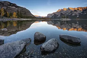 October Prints: Reflections on the shore of Lake Minnewanka in the Canadian Rockies