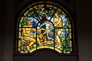 Representations of Adam and Eve on stained glass windows inside Holy Trinity Cathedral
