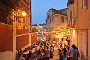 A restaurant in the Calcada do Duque, with a view to the Sao Jorge castle at twilight