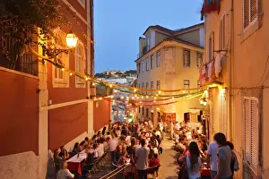 A restaurant in the Calcada do Duque, with a view to the Sao Jorge castle at twilight