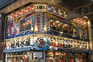 A restaurant lit up at night in Dotombori, Osaka, Kansai, Japan