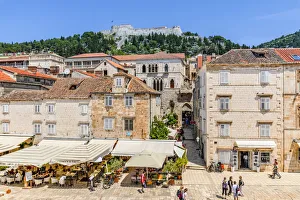 Restaurants and Hvar Fortress, Hvar Town, Hvar, Dalmatian Coast, Croatia, Europe