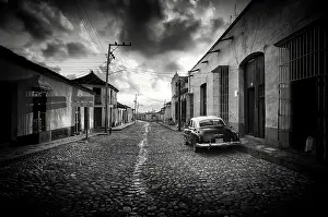Trinidad Prints: Restored classic American car parked on a cobbled street in the old sugar town of Trinidad