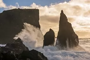 Reykjanes peninsula, Iceland, Europe. Human figure on top of a high cliff with stormy ocean waves