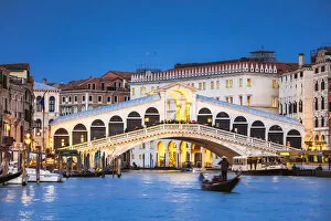 Transportation Collection: Rialto bridge and gondola on the Grand Canal at dusk, Venice, Italy