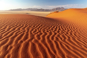 Dunes Prints: Rippled sand dunes with mountains in the distance