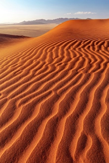Distance Prints: Rippled sand dunes with mountains in the distance