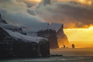 Risin og Kellingin sea stacks and islands of Eysturoy and Streymoy seen from Kallurin (island of Kalsoy) at sunset. Faroe islands