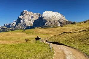 Road leading to Sassolungo and Sassopiatto, Alpe di Siusi, Dolomites, Italy