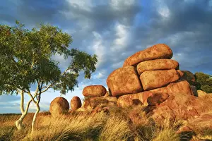 Rock formation at Devils Marbles with eucalyptus tree - Australia, Northern Territory