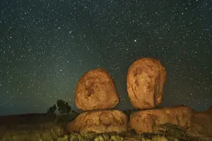 Black Prints: Rock formation at Devils Marbles with star sky - Australia, Northern Territory