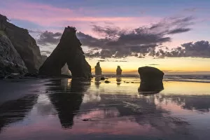 Rock reflect with low tide at the Three Sisters beach, at sunset