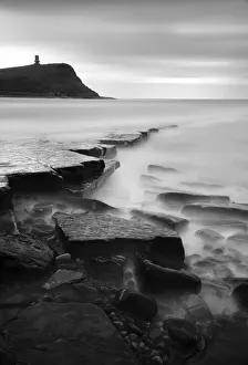 Rocks in Kimmeridge Bay with Clavell Tower in the background, Dorset, UK Rocks in Kimmeridge Bay with Clavell Tower in the background, Dorset, UK