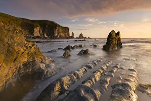 South Hams Prints: Rocky cove in golden evening light, Bantham Beach, South Hams, Devon, UK