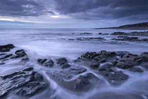 Rocky ledges below Nash Point at dusk on the Glamorgan Heritage Coast, Wales