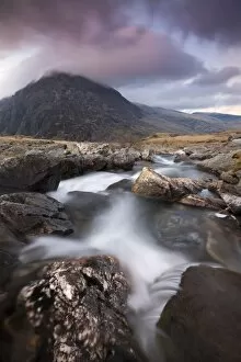 Rocky river in Cwm Idwal leading to Pen yr Ole Wen Mountain at sunset, Snowdonia National Park