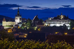 Romania, Transylvania, Sighisoara, elevated city view Old Town and clocktower, dusk