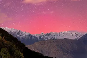 Dramatic Sky Prints: Romantic pink and purple night sky during the Aurora Borealis over the Italian Alps