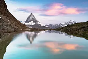 Zermatt Prints: Romantic sunrise over Matterhorn reflected in the calm waters of Riffelsee lake