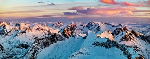Majestic Prints: Romantic sunset over mountain peaks covered with snow