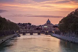 A romantic sunset on Tiber River with bridge Umberto I and Basilica di San Pietro