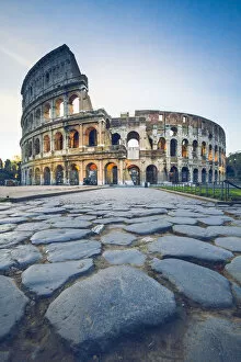 Rome, Lazio, Italy. Colosseum and Via Sacra at sunrise