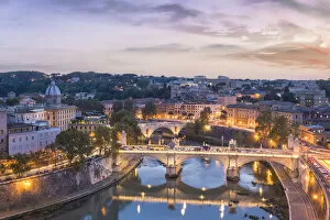 Rome, Lazio, Italy. High angle view of the Roman bridges over the tiber river at dusk