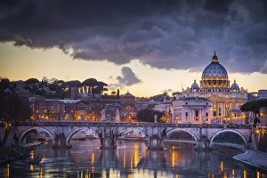 Rome, Lazio, Italy. Sunset on Tevere River, with Saint Peter Cathedral on the background Rome, Lazio, Italy. Sunset on Tevere River, with Saint Peter Cathedral on the background