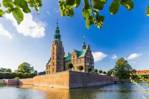 Building Exterior Prints: Rosenborg castle reflecting in the water at sunset in Copenhagen, Denmark