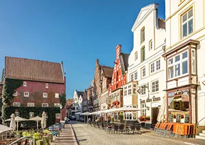 Luneburg Prints: Row of houses at Am Stintmarkt with outdoor terraces, Luneburg, Lower Saxony, Germany