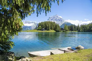 Waters Edge Prints: Rowboat moored on shores of Lake Arnisee with Gross Windgallen mountain in the background